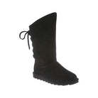 The BEARPAW Phylly Boots for women feature a black suede upper, flat sole, and decorative lace-up back—ideal mid-calf winter boots combining style and warmth.