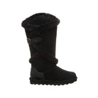 The BEARPAW Sheilah Boots for women feature black suede, mid-calf height, faux fur trim, a decorative buckle strap, and a ridged rubber sole—combining style and warmth.