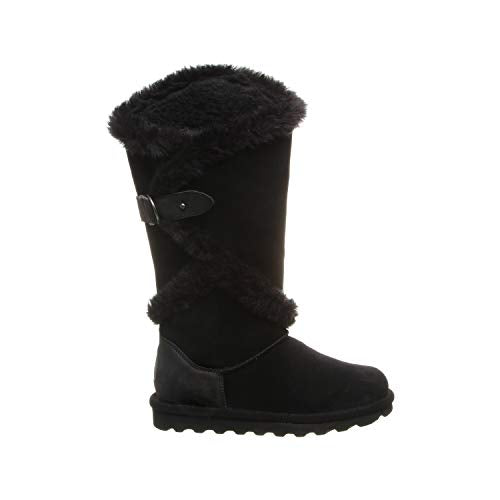 The BEARPAW Sheilah Boots for women feature black suede, mid-calf height, faux fur trim, a decorative buckle strap, and a ridged rubber sole—combining style and warmth.