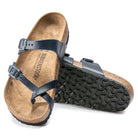 Birkenstock Mayari Oiled Leather sandals for women, featuring dark blue oiled leather straps, a contoured footbed, and black textured rubber soles. One sandal lies flat; the other is propped up to show the sole.
