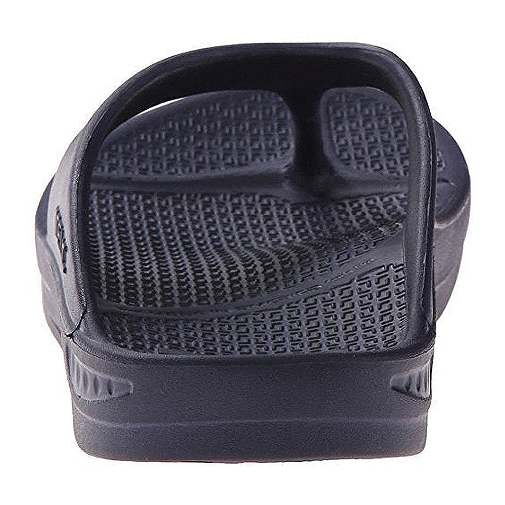 A close-up of the Telic Footwear Energy Flip Flop - Unisex in black highlights its textured footbed and minimalist strap. The sandal, shown on a white background, offers pillow-soft cushioning for comfort.