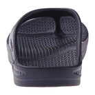 A close-up of the Telic Footwear Energy Flip Flop - Unisex in black highlights its textured footbed and minimalist strap. The sandal, shown on a white background, offers pillow-soft cushioning for comfort.