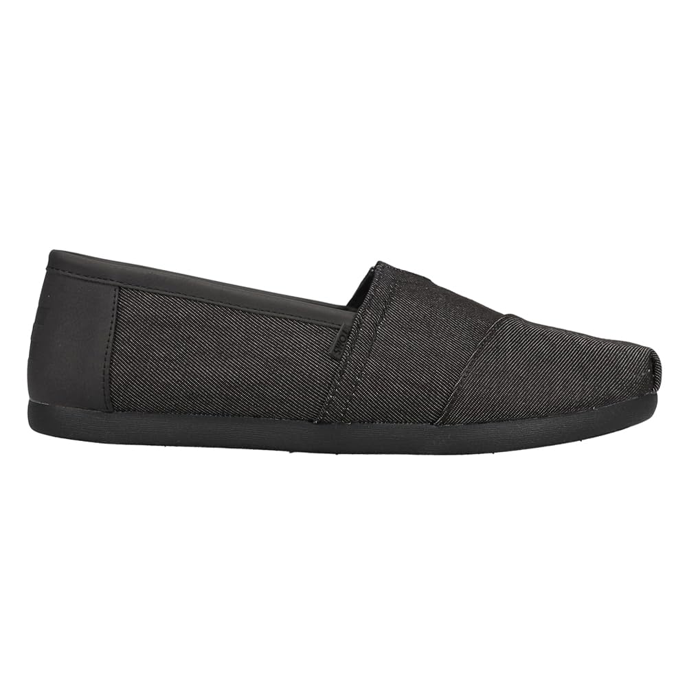 The TOMS Classic Canvas - Men is a black fabric alpargata slip-on with a low profile, rounded toe, elastic upper inset, and flat black sole, shown in side view against a white background.