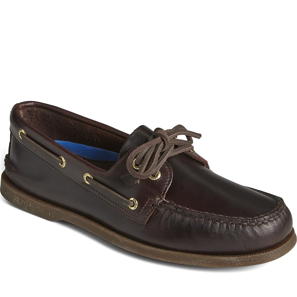 The Sperry A/O 2-EYE LEATHER mens boat shoe features classic moccasin-style stitching, brown laces, gold eyelets, and a flat rubber sole.