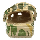 A close-up rear view of the Crocs Classic Camo Clog - Unisex, a comfortable slip-on water shoe with a swiveling heel strap and textured footbed, shown in tan, green, and brown.