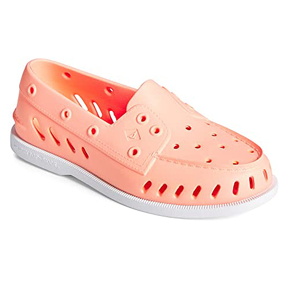The Sperry Authentic Original Float Boat for women is a peach slip-on loafer with ventilation holes, drainage gills, and a white sole, made from lightweight rubber or plastic for easy floating.