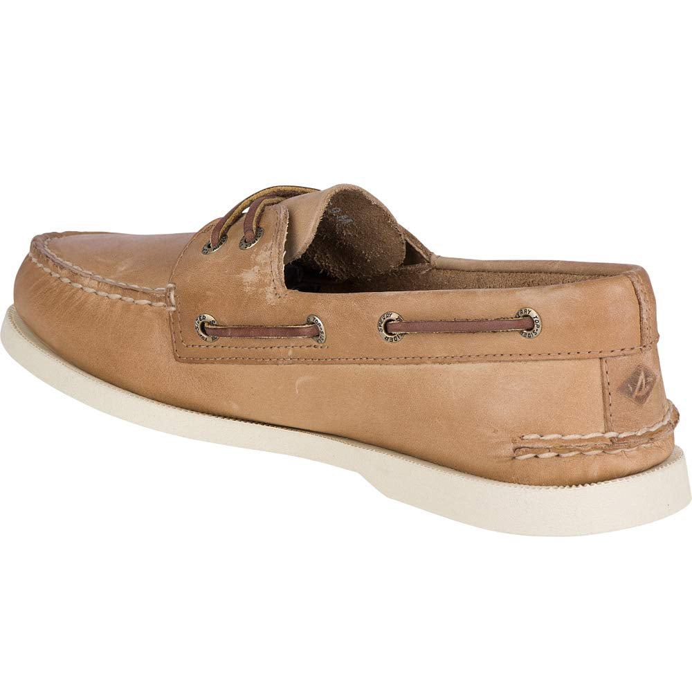 A slightly worn Sperry A/O 2-EYE LEATHER mens boat shoe in tan leather, featuring white stitching, brown leather laces, and a white rubber sole. Shown from a rear side angle.