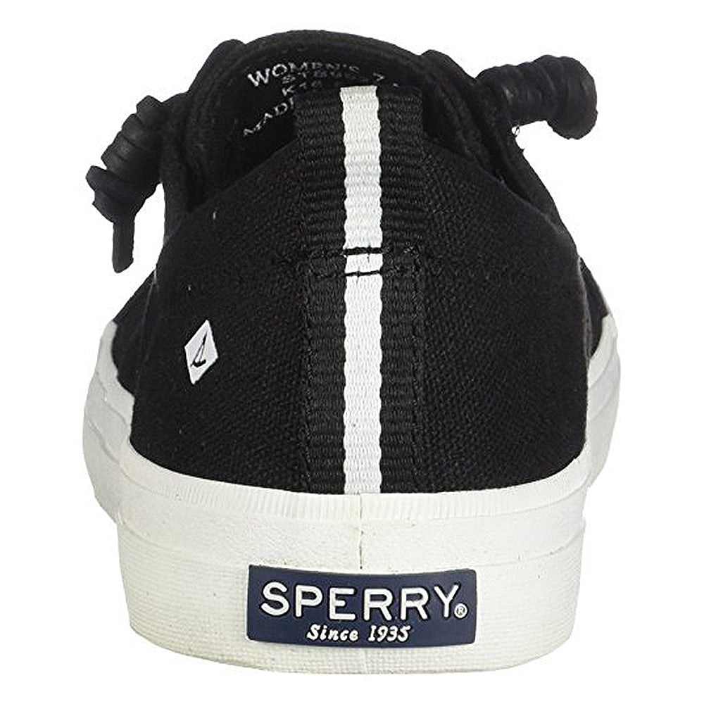 Rear view of the Sperry Crest Vibe - Womens black sneaker featuring a white vertical heel stripe, white sole, Sperry logo label on the back, knotted laces, side logo, and reliable arch support.