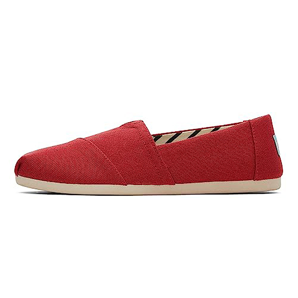 The TOMS Alpargata ESP - Women is a red canvas slip-on with a beige sole, shown from the side against a white background, showcasing the brands signature design.