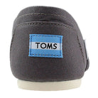 Close-up of the back of a gray TOMS Alpargata ESP - Women shoe, featuring a blue and white TOMS label on the heel, an off-white sole, and the classic slip-on style that reflects TOMS’ signature buy one give one spirit.