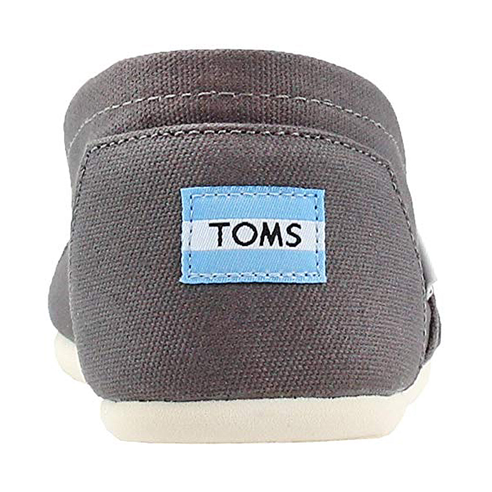 A rear view of the TOMS Alpargata ESP - Women in gray canvas with a white sole. The heel features a blue and white TOMS logo tag, representing their signature buy one, give one initiative.