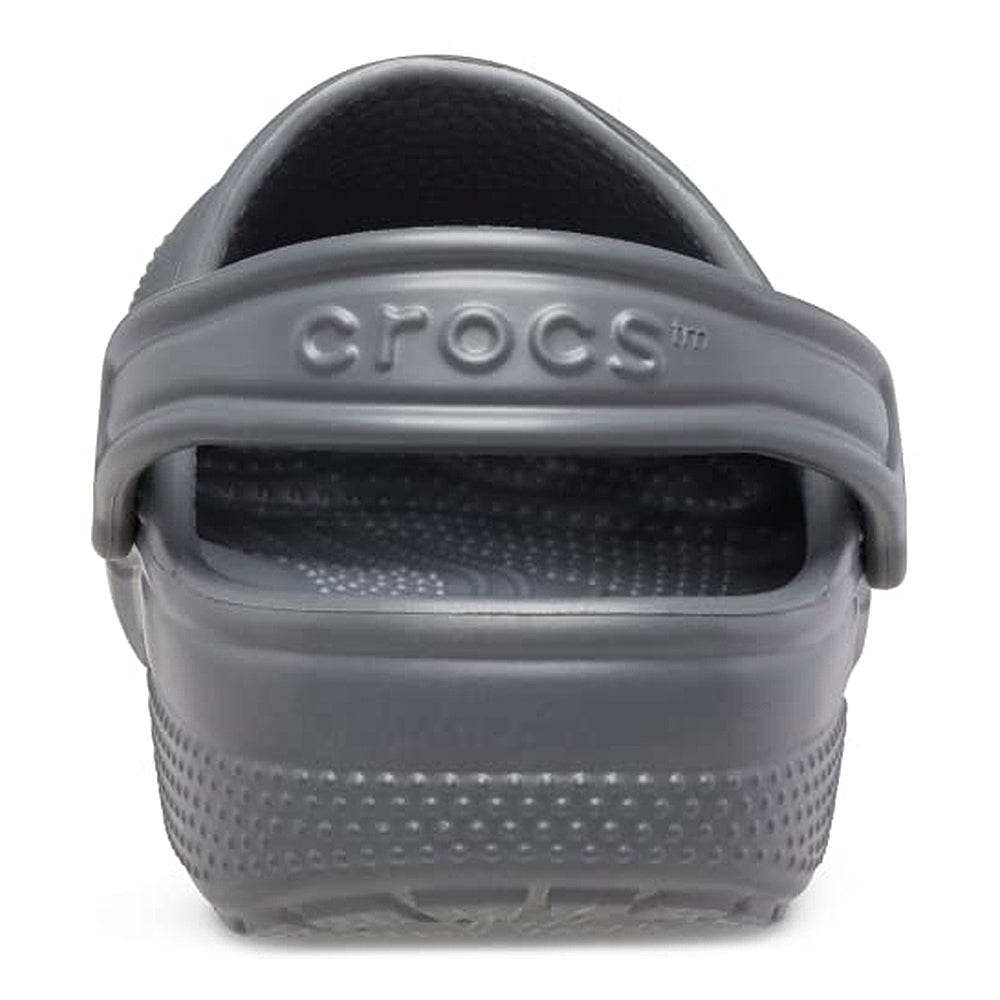 A close-up rear view shows a single gray Crocs Classic Clog - Kids with the heel strap up. The Crocs logo is embossed on the strap, and textured details appear on the heel and sole.