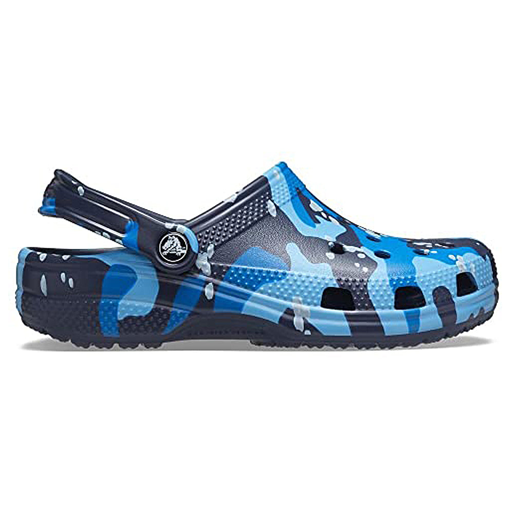 The Crocs Classic Camo Clog - Unisex is shown in side profile on a white background, featuring blue camouflage pattern, heel strap, front and side ventilation holes, and a textured sole.