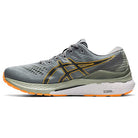 The ASICS Gel Kayano 28 - Mens is a gray stability running shoe with yellow and orange accents, mesh upper, lace-up design, white cushioned sole with orange tread, and GEL technology for comfort.