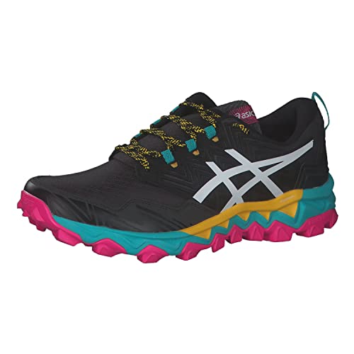 The ASICS GEL-FujiTrabuco 8 Womens sneaker features a black upper with a white logo, yellow and teal accents, patterned laces, a vibrant midsole, and a bright pink rugged outsole—perfect for trail running.