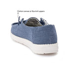 The Hey Dude Wendy Youth - Girls is shown from the back, featuring blue cotton canvas uppers, a white sole, and visible stitching. Text highlights cotton canvas uppers—ideal for lightweight comfort in girls shoes.