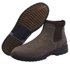 The Hey Dude Scott Grip Boots for men feature weather-ready, water-resistant brown leather, elastic side panels, rugged black soles, and a back pull tab. One boot is upright; the other shows its sole.