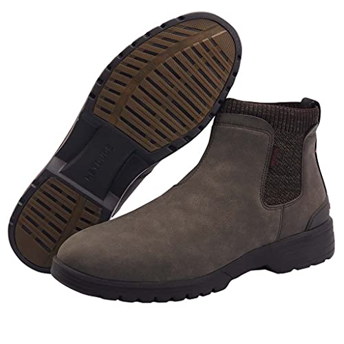 The Hey Dude Scott Grip Boots for men feature weather-ready, water-resistant brown leather, elastic side panels, rugged black soles, and a back pull tab. One boot is upright; the other shows its sole.
