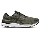 The ASICS Gel Cumulus 24 - Mens in olive green and black features a mesh upper, black laces, white cushioned sole with FF BLAST cushioning, subtle pattern details, and the signature ASICS logo on the side.
