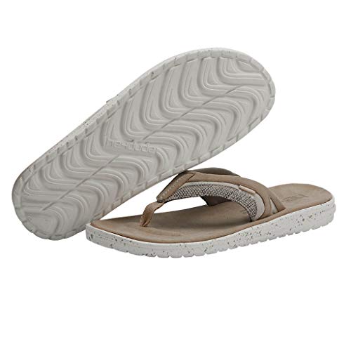 A pair of mens beige Hey Dude Flinn Sandals, featuring textured white rubber soles—one upright, one showing the zigzag tread. Lightweight and comfortable for everyday wear.