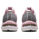Rear view of ASICS Gel Nimbus 23 - Womens running shoes featuring gray uppers, pink accents, white soles, and visible gel cushioning in the midsole for enhanced shock absorption.