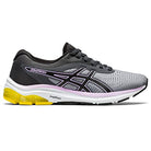 The ASICS GEL-PULSE 12 Womens Running Shoe features a gray and black design with a white sole, yellow heel accent, black laces, purple detail on the side logo, and a breathable engineered mesh upper.