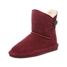 A single BEARPAW Rosie Youth Boot in maroon suede with a cream fleece lining, decorative side button, sheepskin footbed, and flat rubber sole, shown from the side on a plain white background.