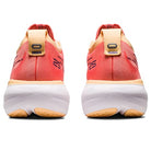 Rear view of the ASICS Gel Nimbus 25 - Womens, showing orange and peach tones with white soles and black accents. The heel highlights ASICS branding and lightweight cushioning for comfort in these running shoes.