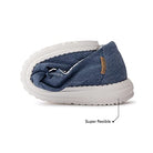 A blue casual shoe with a white sole is bent in half to highlight its super flexible design. A label reads Super flexible, showing why Hey Dude Wendy Youth - Girls is a top pick for lightweight women’s shoes.