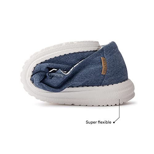 A blue casual shoe with a white sole is bent in half to highlight its super flexible design. A label reads Super flexible, showing why Hey Dude Wendy Youth - Girls is a top pick for lightweight women’s shoes.