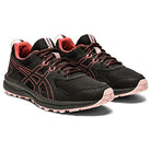 The ASICS Trail Scout - Womens features a black mesh upper with pink accents, lace-up design, textured rubber soles, and visible branding—ideal trail running shoes for women.