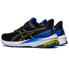 A pair of ASICS GT-1000 12 - Mens running shoes in black with blue and white soles, yellow accents, and a distinctive logo—designed for overpronation. One shoe is shown facing forward, the other backward.