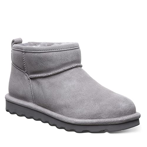 The BEARPAW Shorty Boots - Womens is shown in gray suede with a flat textured rubber sole, rounded toe, and plush lining, captured from a side angle on a white background—ideal for cozy all-day comfort.