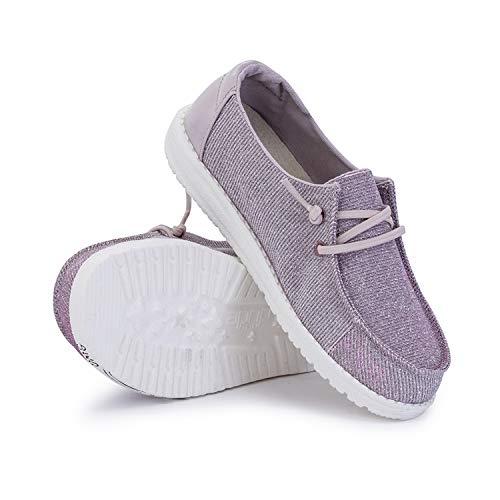A pair of light purple Hey Dude Wendy Youth - Girls shoes with white textured soles and laces, shown with one standing upright and the other on its side to highlight the sole—ideal lightweight comfort for everyday wear.