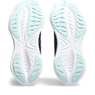 The image shows the soles of the ASICS Gel-Cumulus 25 - Womens, neutral everyday trainer running shoes with a white base, light blue accents, and leaf-like traction patterns. The ASICS brand name appears on each heel area.