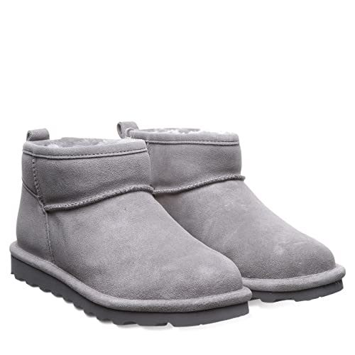 The BEARPAW Shorty Boots for women feature light gray suede, a rounded toe, visible stitching, plush shearling lining, flat ridged soles, and a back pull tab.