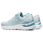 A pair of light blue ASICS Cumulus 23 - Womens running shoes with white soles and subtle ASICS side logos, featuring lightweight cushioning, displayed on a plain white background.
