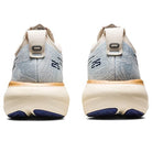 Rear view of ASICS Gel Nimbus 25 - Womens running shoes in light blue and white, with beige soles, navy 25 heel details, dark blue outsole accents, and lightweight cushioning for comfort.