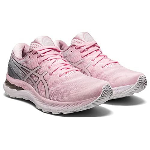 The ASICS Gel Nimbus 23 - Womens features a pink upper, white soles, gray heel accents, and side ASICS logos, designed for enhanced shock absorption.