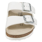 The Birkenstock Arizona - Womens sandal features two wide silver-buckled straps, a tan cork footbed for orthopedic comfort, and a white sole. Inspired by classic Birkenstock design, its shown from the front at a slight angle.