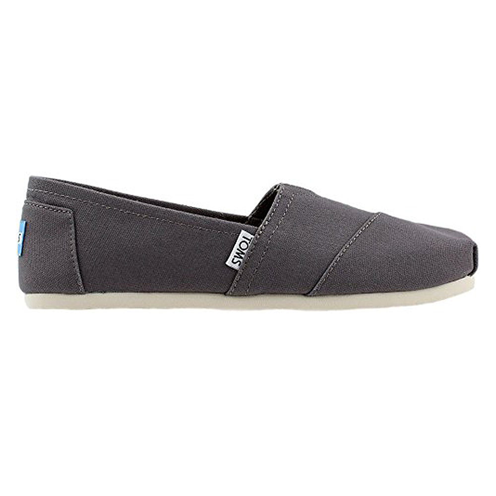 A side view of the TOMS Alpargata ESP - Women shows its gray slip-on canvas style, white sole, and small TOMS tag near the heel, highlighting the brands signature comfortable design.