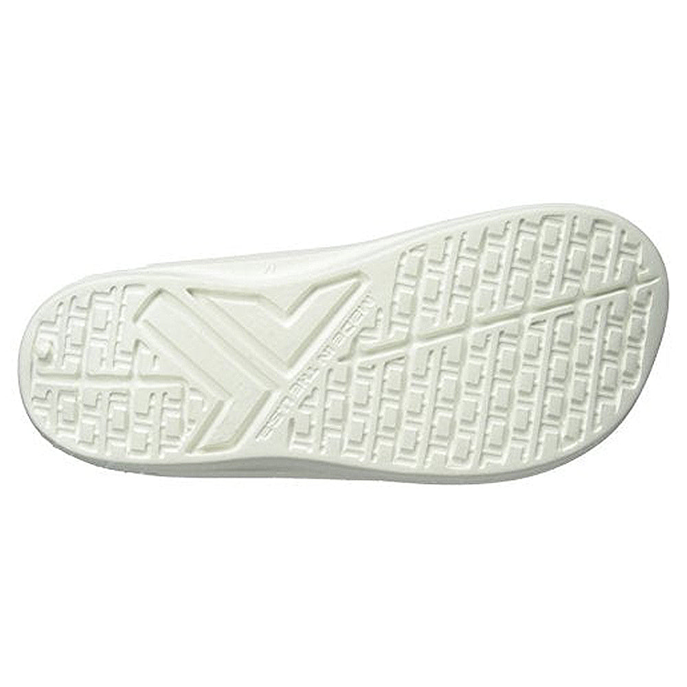 The image displays the white rubber sole of the Telic Footwear Energy Flip Flop - Unisex, featuring a textured grip pattern with diagonal lines and a prominent V at the heel, designed for superior arch support.