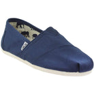 The TOMS Classic Canvas - Men is a navy blue slip-on featuring a white sole, signature side label, and an inner lining with black animal silhouettes.