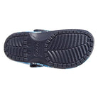 The image shows the sole of a Crocs Classic Camo Clog - Unisex, featuring a textured tread for grip and the Crocs logo embossed in the center, highlighting these comfortable unisex slip-on water shoes.