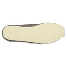 A top-down view of the TOMS Classic Canvas - Men alpargata sole displays a light beige, textured rubber surface with a subtle pattern. The slip-on shoe features a classic design in gray or taupe canvas.