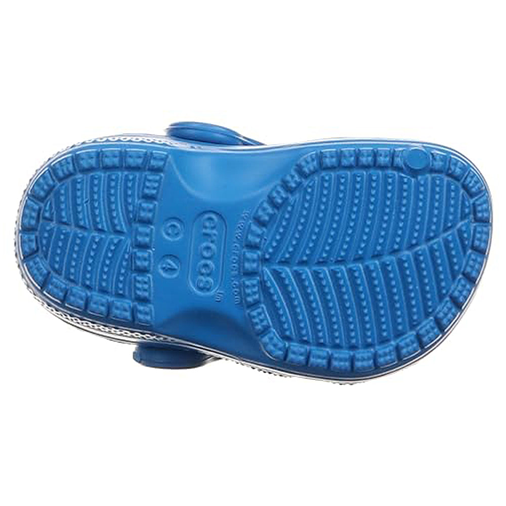 The image shows the sole of a blue Classic Clog - Kids by Crocs turned upward, highlighting its textured tread pattern and the Crocs logo centered on the bottom.