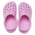 The Crocs Classic Clog - Kids in light pink features ventilation holes and adjustable heel straps, shown from above—ideal everyday shoes for kids that offer comfort and classic style.