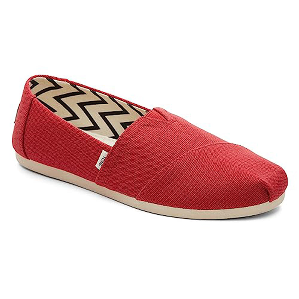 The TOMS Alpargata ESP - Women is a red canvas slip-on with a beige rubber sole, zigzag inner lining, and white tag—crafted with TOMS renowned One for One® giving promise.