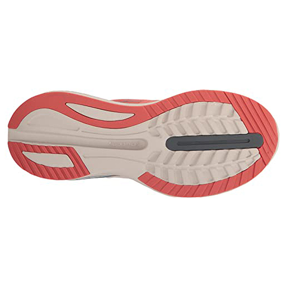 The image displays the sole of the Saucony Guide 16 Running Shoe - Womens, with beige, red, and black sections and diverse tread patterns designed for enhanced grip and cushioned support.