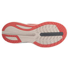 The image displays the sole of the Saucony Guide 16 Running Shoe - Womens, with beige, red, and black sections and diverse tread patterns designed for enhanced grip and cushioned support.